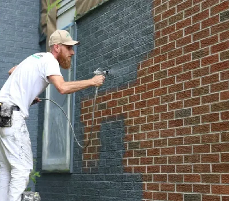 Spray-painting-a-houses-brick-exterior-in-Scio-Township